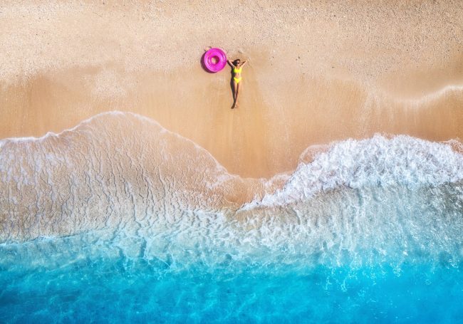 Aerial,View,Of,The,Lying,Beautiful,Young,Woman,With,Pink